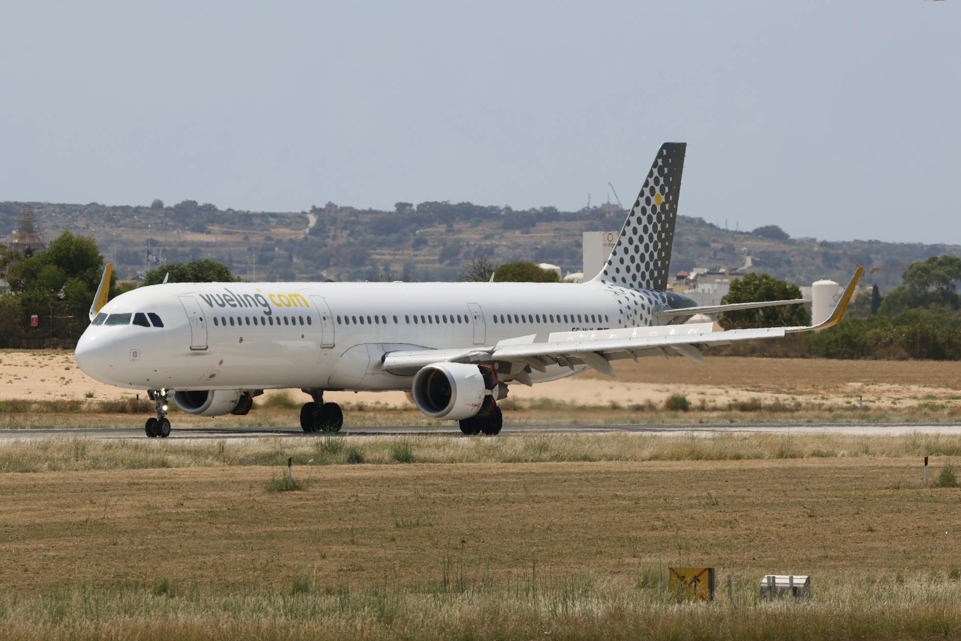 airplane on runway at sunny airport day