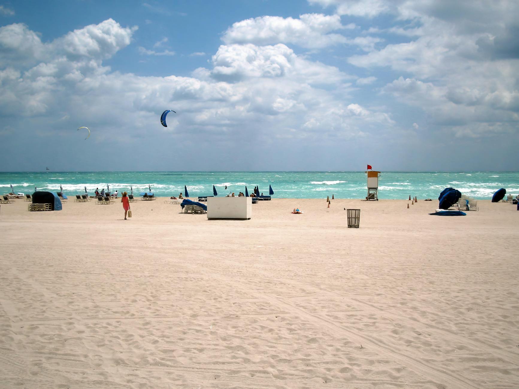sunny day at miami beach with kite surfers