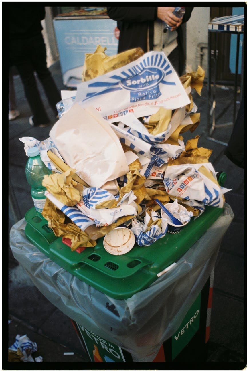 overflowing garbage bin on a naples street