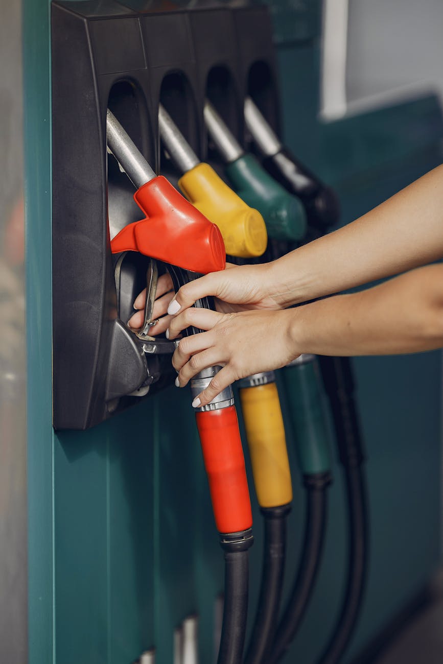 crop woman taking refueling pistol gun