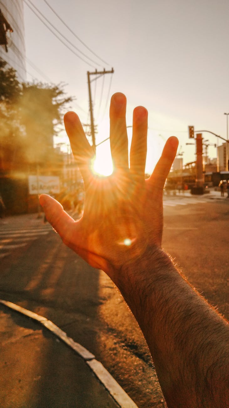 a hand covering sun glare