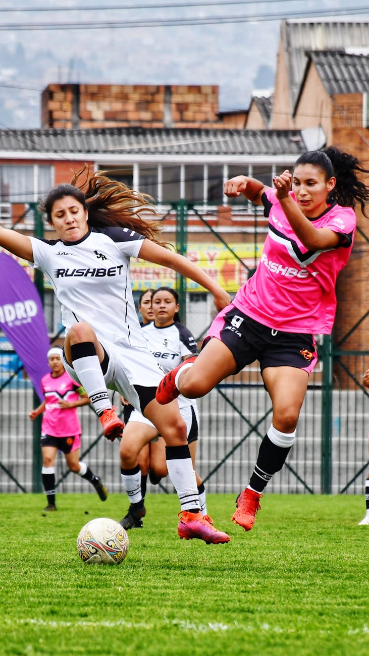 athletes playing soccer on the field