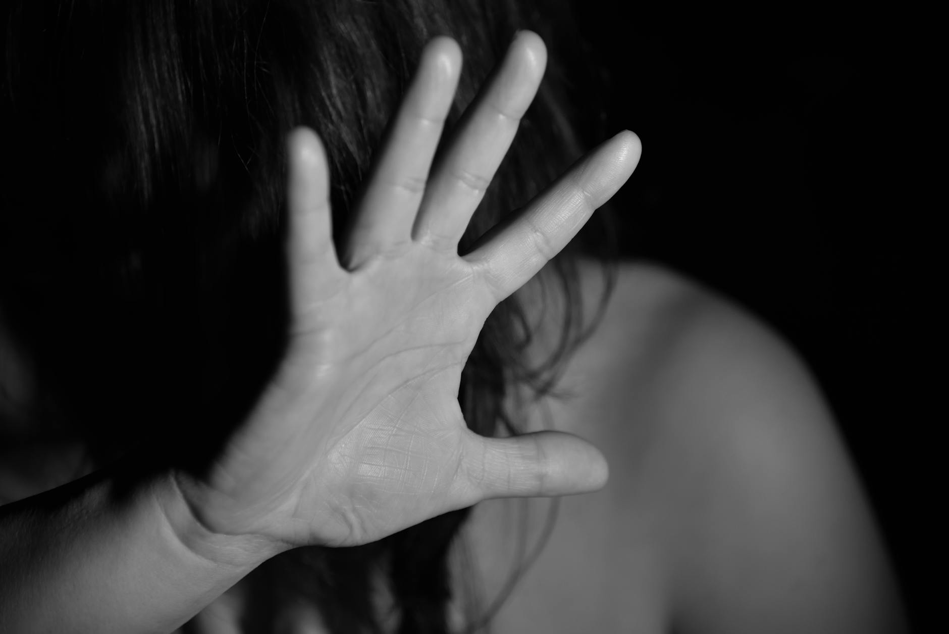 face obscured by hand